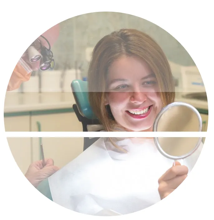 Happy patient admiring her new smile in a hand mirror at Harajda Dent